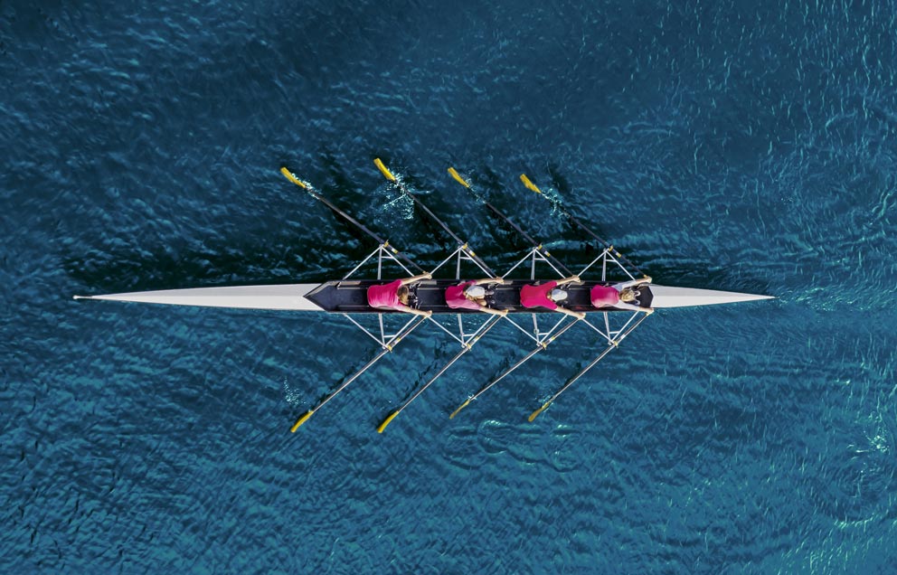 Women's Rowing Team On Blue Water